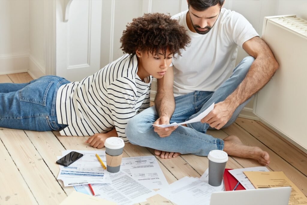 Homeowner calculating mortgage overpayments and interest savings on a laptop.